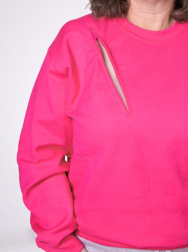 A person wearing a pink sweatshirt with a knife on the arm.